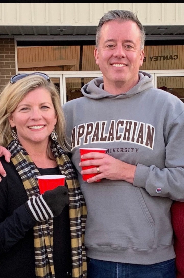 Donna and Seth Marlowe, both in Appalachian gear, on a crisp fall day